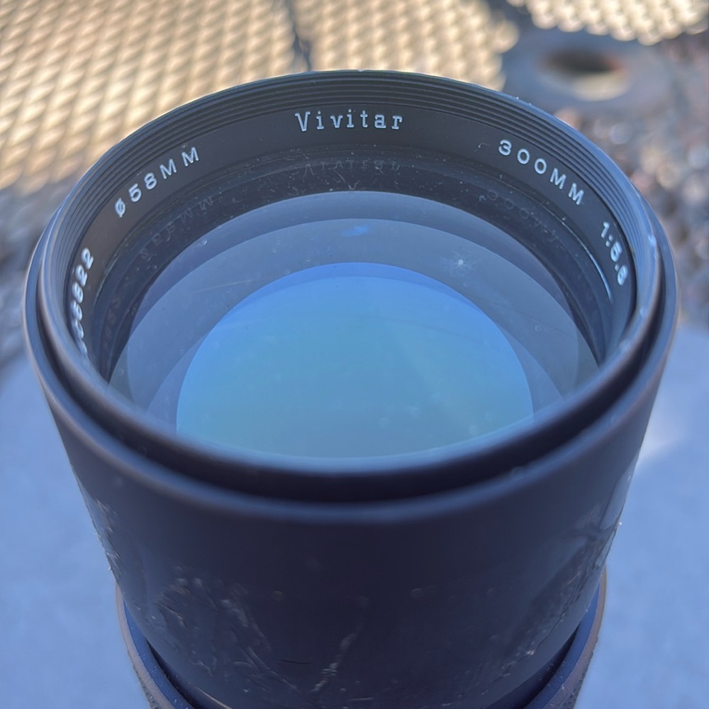 The image shows a Vivitar 300mm 1:5.6 lens. Additional information: